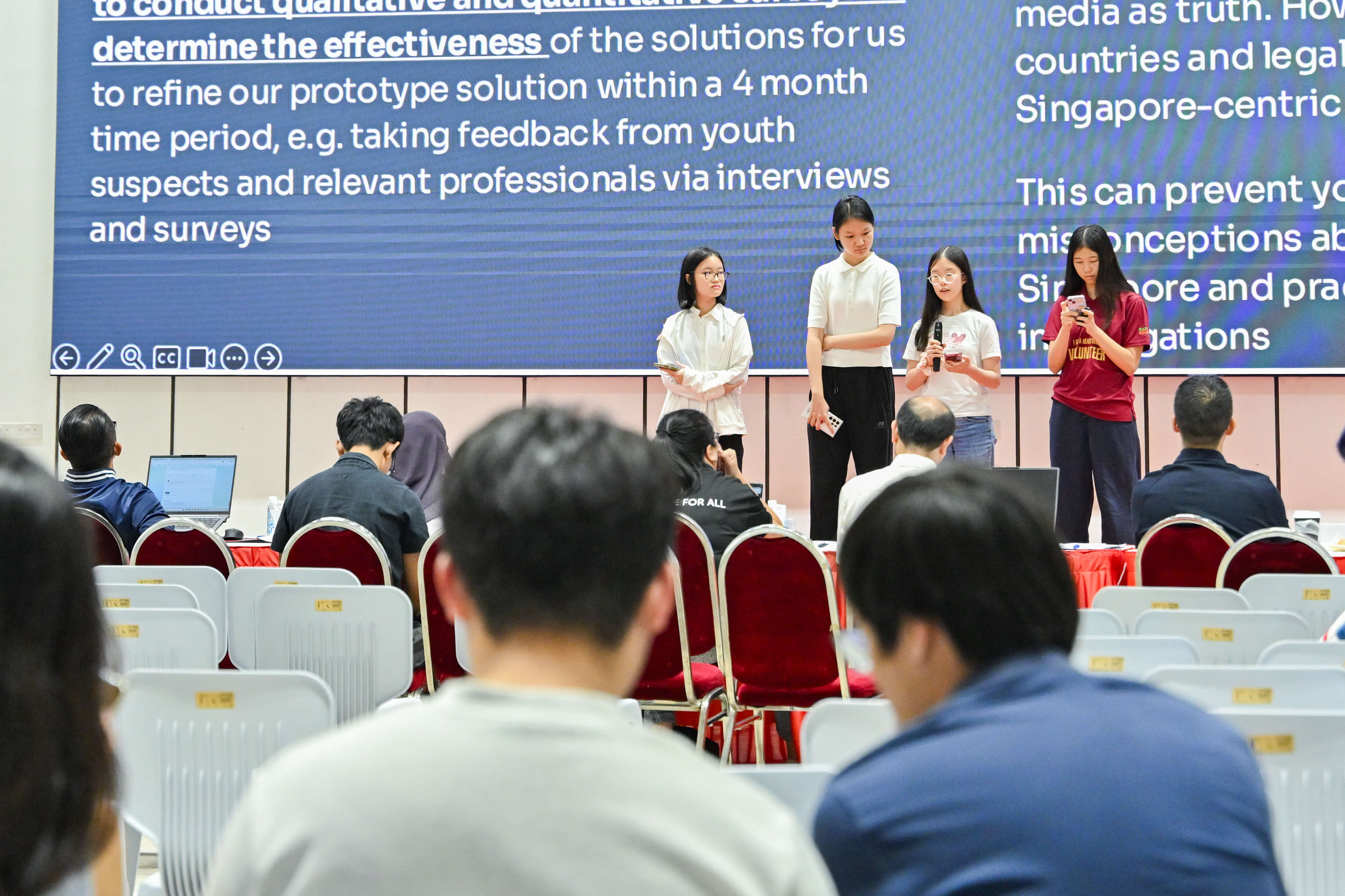 Four students sharing with the audience and judges
